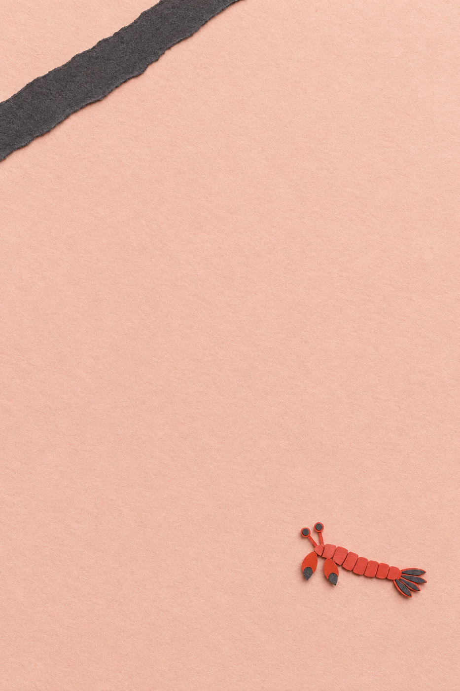 A tiny red paper mantis shrimp motif sits near the lower-right corner of blush paper opposite one charcoal strip.
